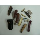 A selection of pen knives including a Leopard in leather belt case