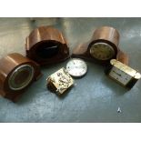 A clock mechanism, two walnut mantle clock casings, a mahogany mantle clock casing,