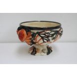 A hand painted majolica fruit bowl with applique crab handles and shells to the base,