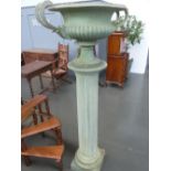 A composite urn with twin banded scrolling handles,