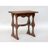 An Arts & Crafts elm centre table, rectangular top on four baluster legs, united by X stretcher,