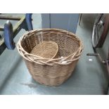 An oval shaped wicker laundry basket (45cmH) with a small waste paper bin