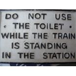 A cast iron railway sign, Do Not Use The Toilet While The Train Is Standing In The Station, 28.