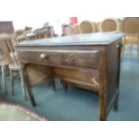 An oak side table with side panels, rectangular top over long drawer with turned brass knob,