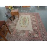 A Caucasian rug, red fields, with fifteen lozenges to centre, with geometric bordering,