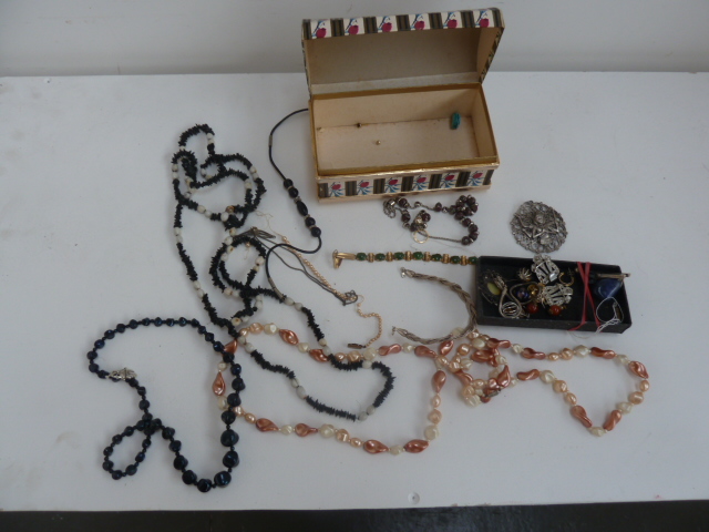 A box of jewellery to include necklaces, bracelets, and brooch,