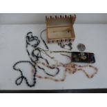 A box of jewellery to include necklaces, bracelets, and brooch,