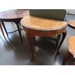 A 20th century burr walnut veneered side table, demi lune form , carved border,