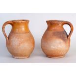 Two large Verwood pottery jugs, the top quarter decorated in a warm glaze, with a wide strap handle,