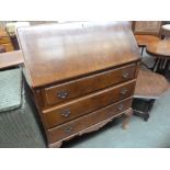 A 20th century walnut bureau, drop  down front with red leather skiver, above three drawers,