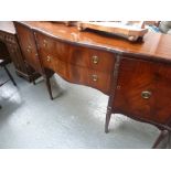 A George III style mahogany and ebony inlay bow fronted sideboard, two cupboards flanking drawers,