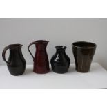 A quantity of Art Pottery to include a red glazed jug, a dark green glazed jug,