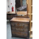 An early 20th century oak dressing chest with mirror over three drawers on tapering feet 74cmW x