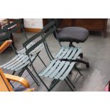 Four green painted, slatted, metal, foldable garden chairs, with table,