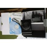 A Samsung NV 100HD digital camera with accessories and box