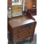 A 1930's oak dressing table with triple mirror over two drawers on bracket feet,