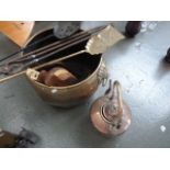 A large 19th century brass log basket, with twin lion mask ring handles, with fireside tools,