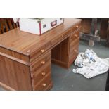 A George III style pine knee hole desk, rectangular top over an arrangement of eight drawers,