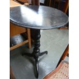 A Victorian ebonized tripod table