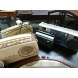 Four vintage radios to include a Triumph RR3010, two Bush and a PYE with an oval mirror,