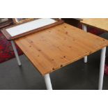 A modern pine table with white painted turned legs,