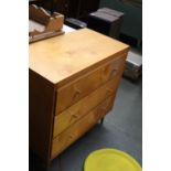 A 1960's three drawer chest raised on turned tapering legs 76cmW x 74cmH