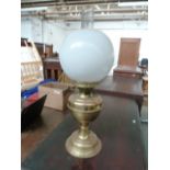 An early 20th century Duplex brass oil lamp, with chimney and shade,