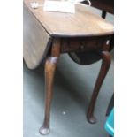 An 18th century oak Pembroke table, frieze drawer with brass drop handle, raised on cabriole legs,