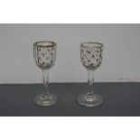 A pair of 18th Century faceted stem glasses with hand painted gilt star pattern and gilt rims 10cmH
