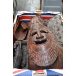 A selection of wooden items to include African masks,