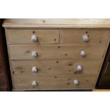 A 19th century pine chest, with two short drawers over three long, raised on shallow feet,