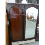 A 20th century mahogany wardrobe, one mirrored door, with drawers below,