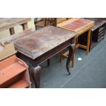 A French stained wood table with tapering cabriole legs and drawer