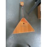A three string triangular banjo/lute