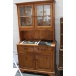 A 20th Century pine dresser two glazed doors over rectangular top over two short drawers and two