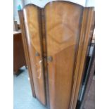 An early 20th century armoire with bow double doors,