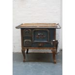 An early 20th century German cast iron Stove, blue painted with cabriole legs,