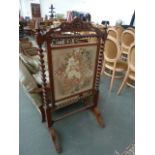 A Victorian rosewood tapestry fire screen, with barley twist supports and stretchers,
