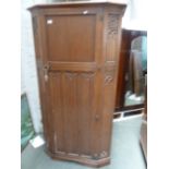 A 20th century oak armoire, by Crown AY Furniture, three panel front,