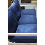 A modern sofa bed with wooden frame and blue cushions