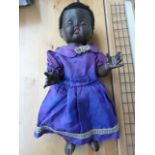 A Vintage Rosebud black plastic doll with purple dress