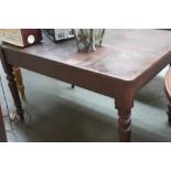 A Victorian painted pine kitchen table with a drawer on turned legs,
