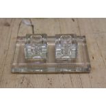 An Art Deco cut glass inkwell and stand, two square inkwells on glass base,