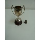 An early 20th century silver trophy, Birmingham 1928, with a silver thimble, (1.