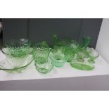 A large quantity of Art Deco style green glass ware, to include glasses, candlesticks,