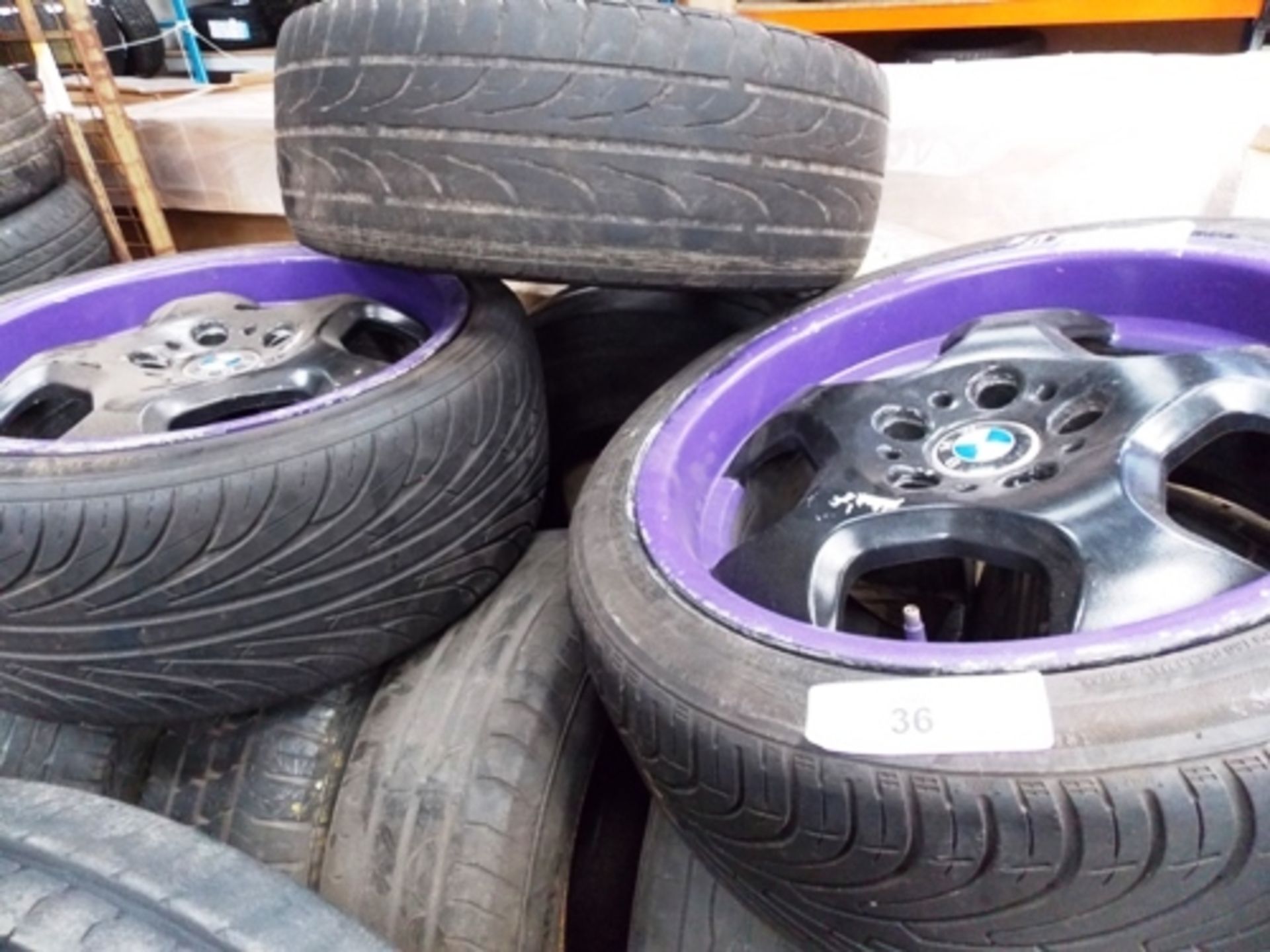 A good quantity of second-hand tyres, together with 2 x BMW sports rims, colour black/purple, both