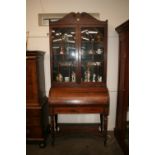 An early 19th Century rosewood and brass inlaid cylinder bureau bookcase,