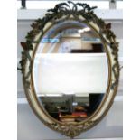 A 19th Century oval painted wall mirror, with foliate and ribbon tied applied decoration,