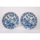 A pair of 18th Century Delft chargers, decorated flowers and birds, 35cm dia.