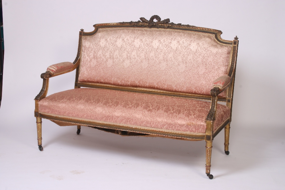 A 19th Century gilt wood salon settee, the cresting rail decorated with garlands,